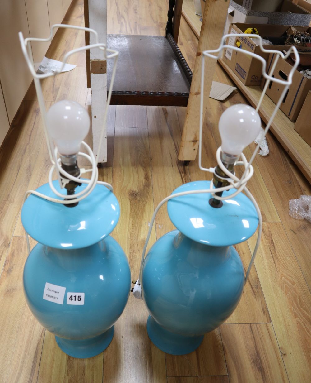 A pair of turquoise glazed baluster table lamps, with pleated cream shades, height 49cm